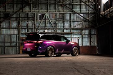 Right rear view of the INFINTI QX80 R-Spec build parked inside a warehouse.
