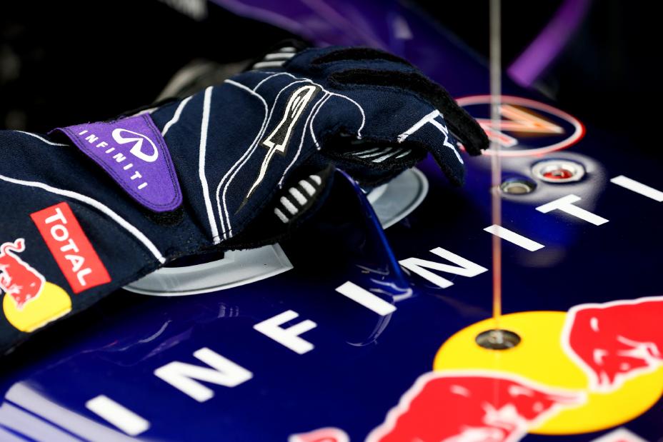 Drivers gloves holding onto the body of the race car.