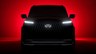 Front view of an INFINITI SUV Concept, it is back lit with red light.