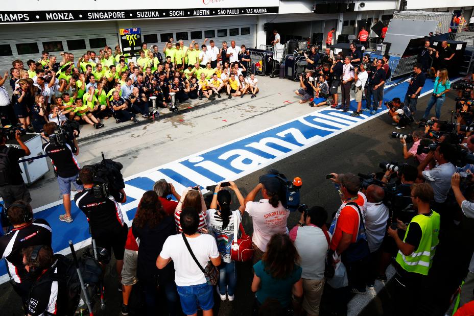 Crowd of cameras and news crews surrounding the INFINITI crew after a win