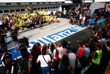 Crowd of cameras and news crews surrounding the INFINITI crew after a win