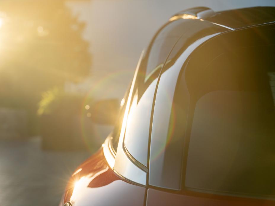 Close up of the rear corner of the 2027 INFINITI QX65 in direct sunlight.