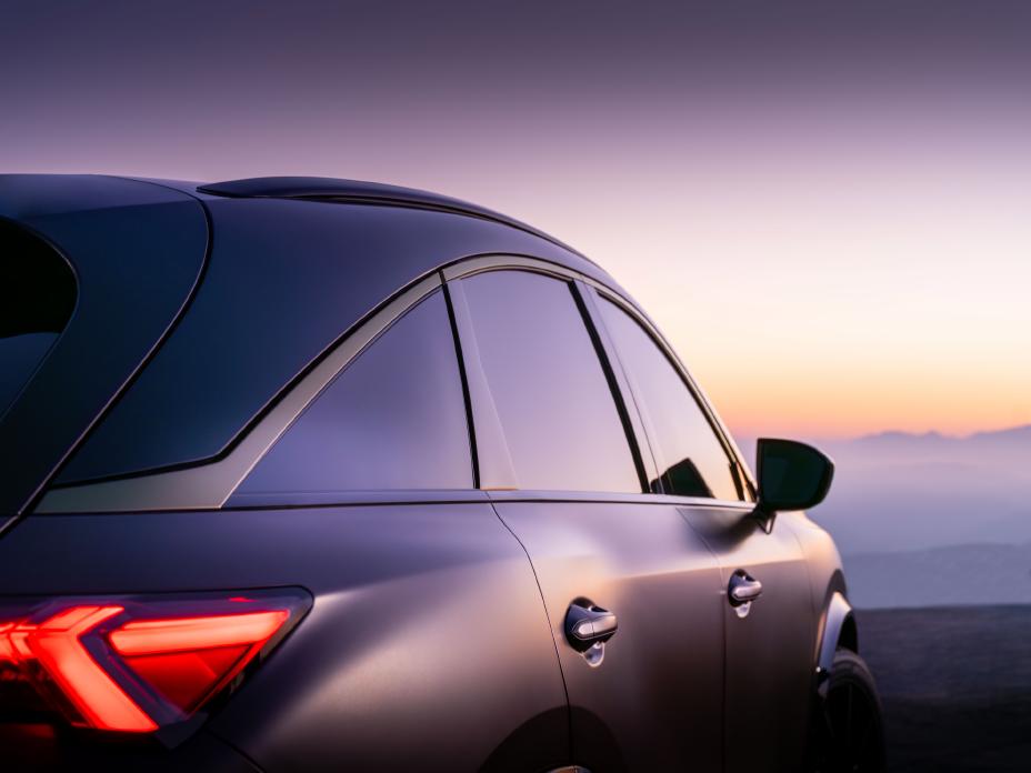 Close up angled view of the QX65 Monograph at sunset, the taillights are illuminated.