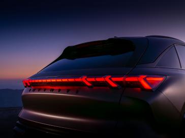 Angled close up of the rear side of the QX65 Monograph, taillights are illuminated.