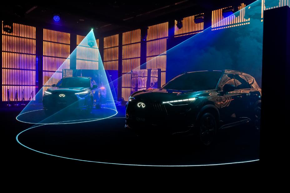 Side angled view of the INFINITI QX60 and QX60S displayed with blue lighting effects