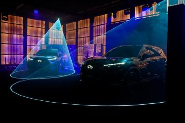 Side angled view of the INFINITI QX60 and QX60S displayed with blue lighting effects