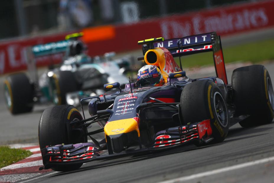 A Formula One Infiniti race car driver driving on the track at the Canadian Grand Prix.