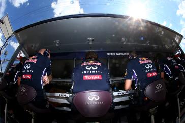 Three men sitting side by side on computers