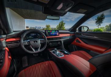 The steering, dashboard and windshield inside the 2027 INFINITI QX65.