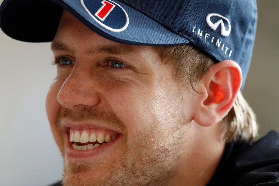 A photo of an INFINITI Formula One racer smiling in a blue cap