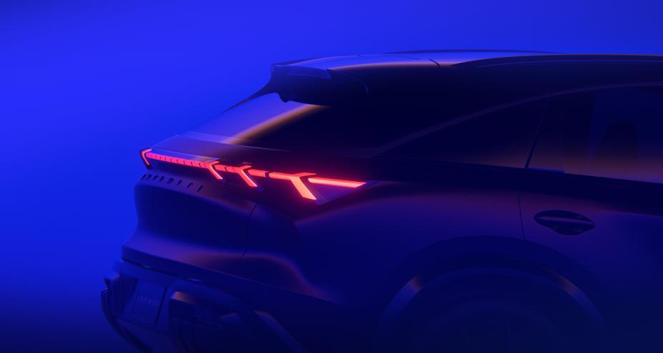 Partial rear profile view of the QX65 Monograph, a haze of electric blue light covers the room.