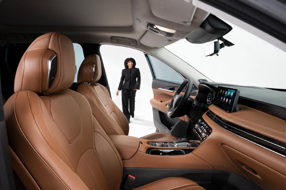 Front view of person stepping toward the open door of an SUV