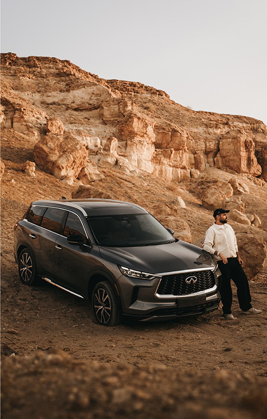Side view of black SUV parked on a rocky trail