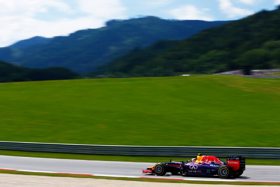 Austrian Grand Prix Race- Left side view of a racecar on the track with mountains in the background