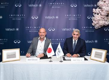 Executives signing at a corporate ceremony