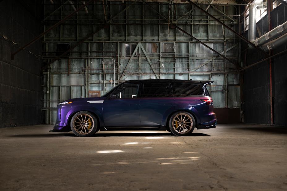 Left profile view of the QX80 R-Spec build parked inside a warehouse, light shines through the windows.