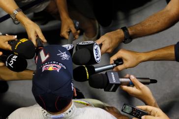 A person wearing Infiniti team hat 1 doing an interview.