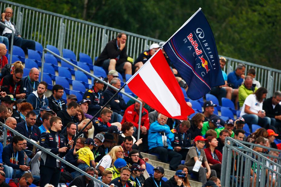Fans waiving a Red Bull Infiniti racing flag.