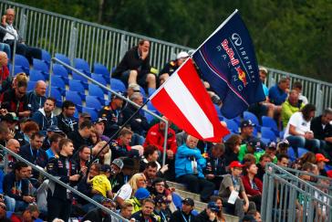 Fans waiving a Red Bull Infiniti racing flag.