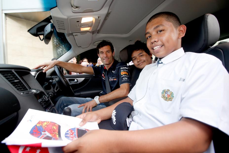 Infiniti team sitting inside a car.