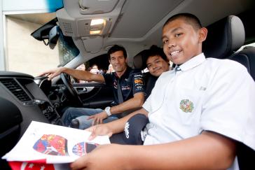 Infiniti team sitting inside a car.