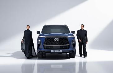 Full front view of the QX80S with two people walking alongside it