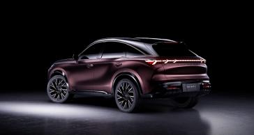 Left rear 3/4 view of the QX65 Monograph in a dark room with minimal light.