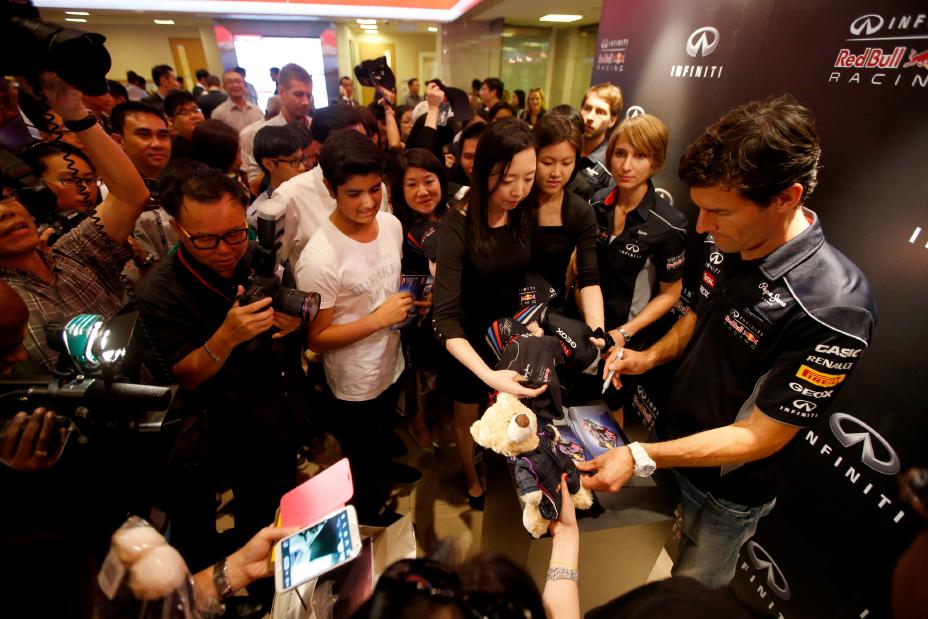 Infiniti Red Bull racing team signing autographs.