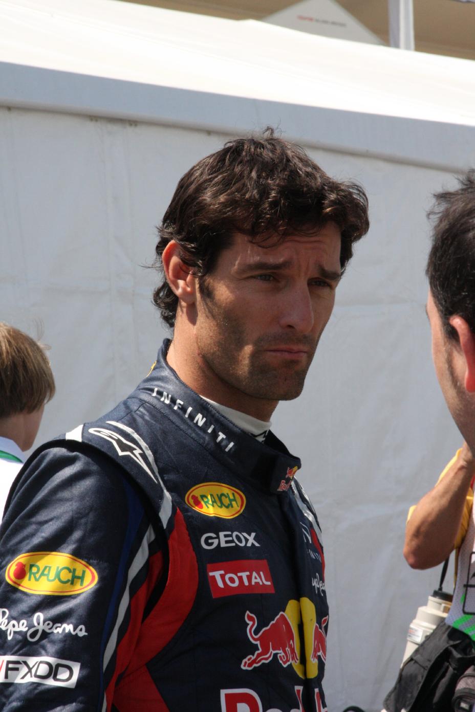 A photo of Mark Webber talking to someone