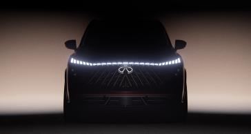 Front view of the QX65 Monograph, the headlights are illuminated and span the full width of the vehicle.