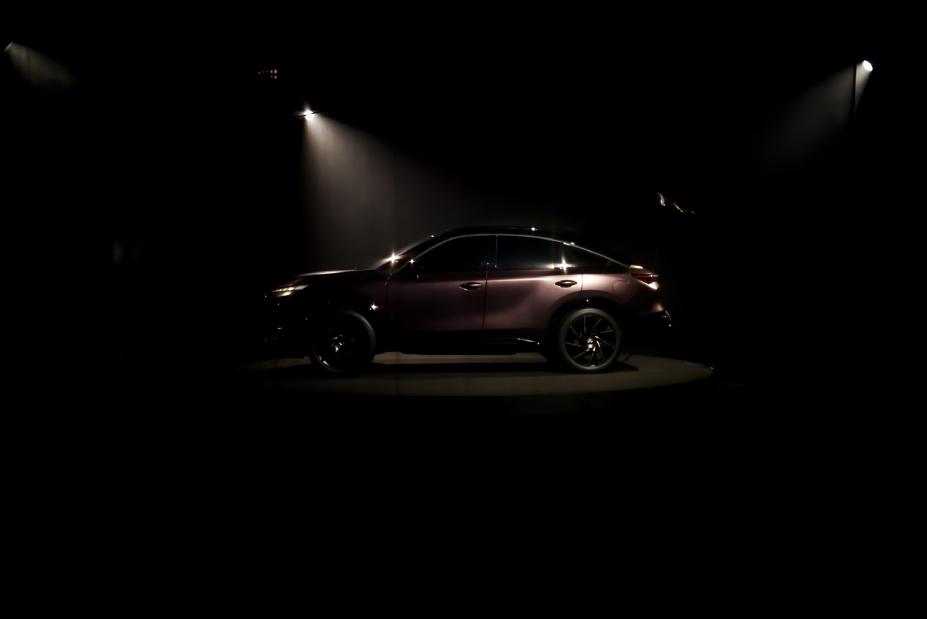 Full-side profile view of the INFINITI QX65 Monograph against dark background