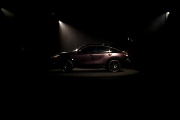 Full-side profile view of the INFINITI QX65 Monograph against dark background