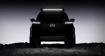 Front view of an INFINITI Concept, the headlights and emblem are illuminated, a light bar is attached to the roof.