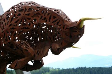 Right side image of Image of a brown bull statue with gold horns