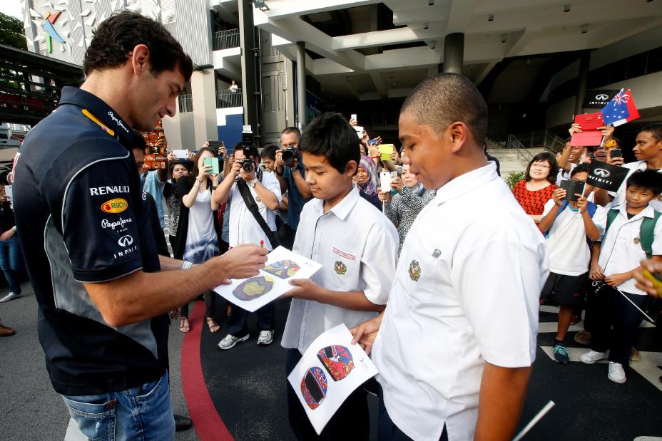 Infiniti F1 driver signing autographs.