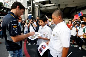 Infiniti F1 driver signing autographs.