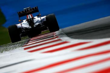 F1 car driving on the side of the track.