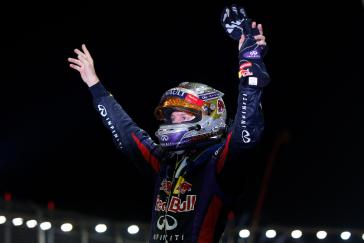 Infiniti driver celebrating with his hands up.
