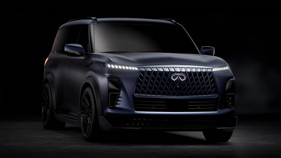 Front right 3/4 view of the INFINITI QX80 Track Spec mostly in the dark, the headlights are illuminated.