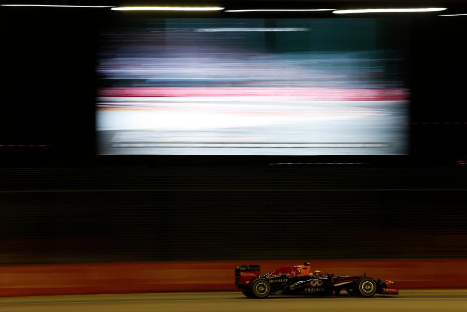 Side view of F1 car driving on the track.