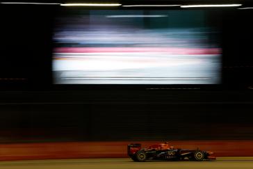 Side view of F1 car driving on the track.