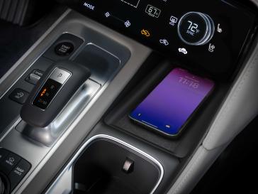 Close up of the center console controls with the area to set a smart phone inside the 2026 INFINITI QX60.