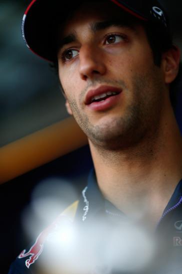 Headshot of INFINITI driver in a baseball cap looking off to the side