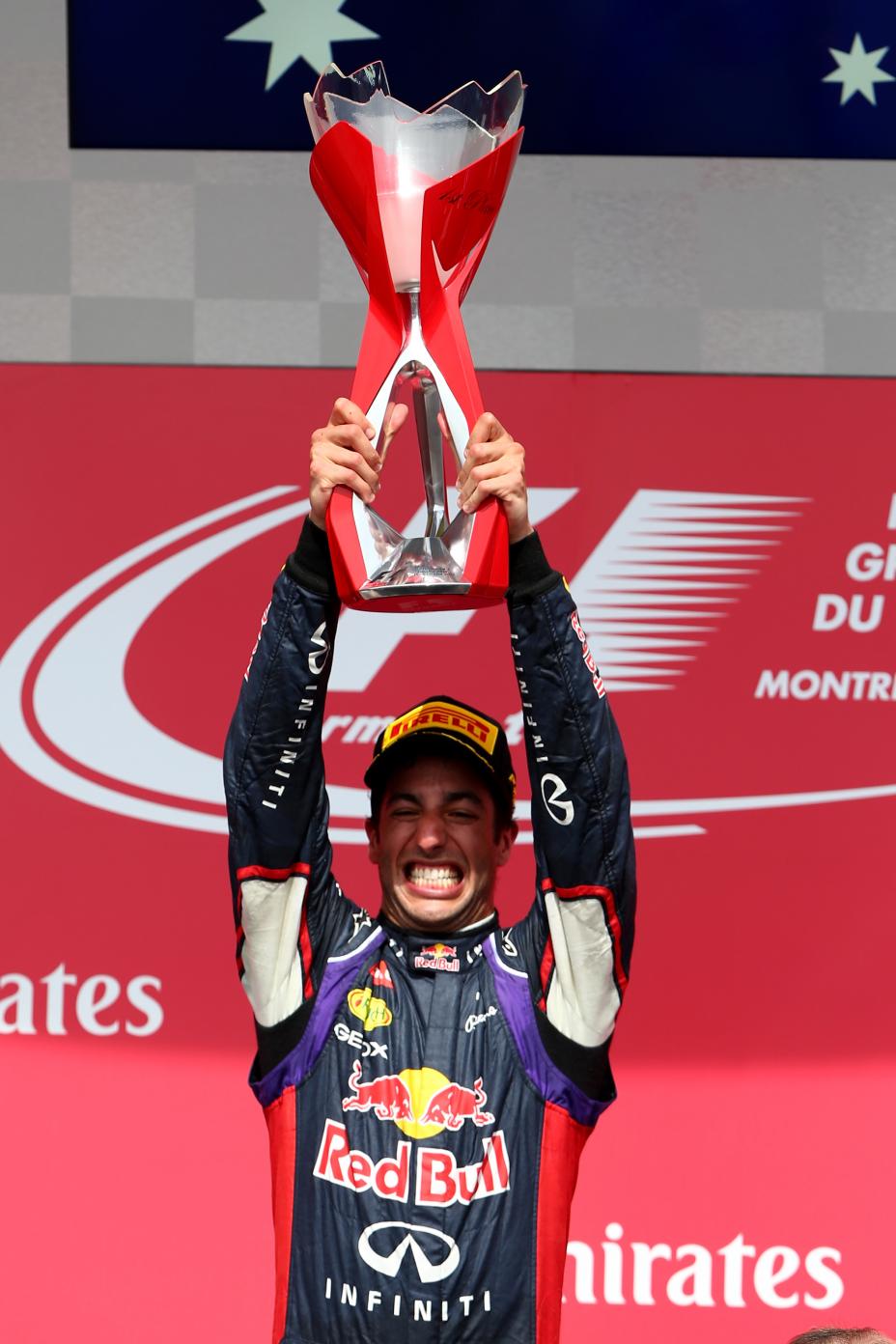 Red Bull team hosting the Canadian Grand Prix trophy up.
