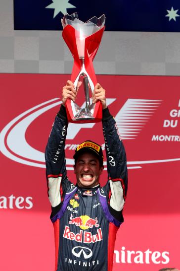 Red Bull team hosting the Canadian Grand Prix trophy up.