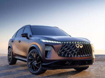 Front right 3/4 angle of the QX65 Monograph at sunset with the headlights on.
