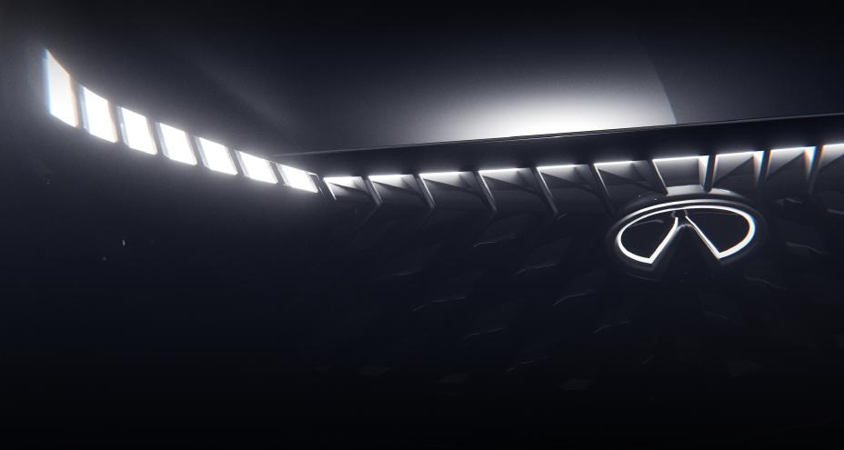 Close up of the grill on an INFINITI Concept, the headlights and emblem are illuminated.