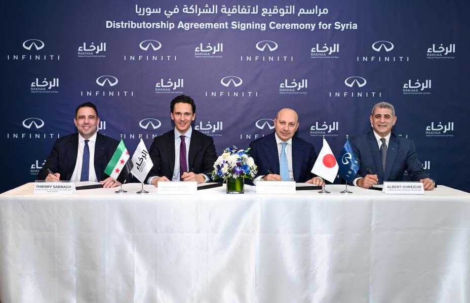 Front-facing group of executives signing at a formal corporate ceremony