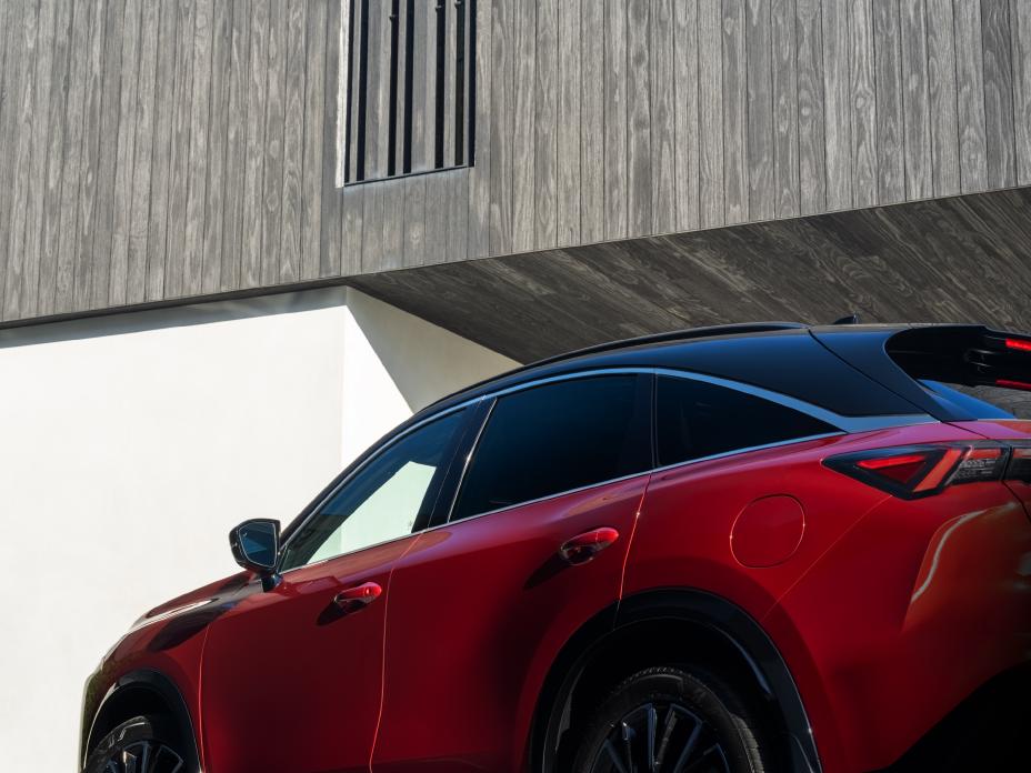 Low angled view of the 2027 INFINITI QX65 parked near a modern building.