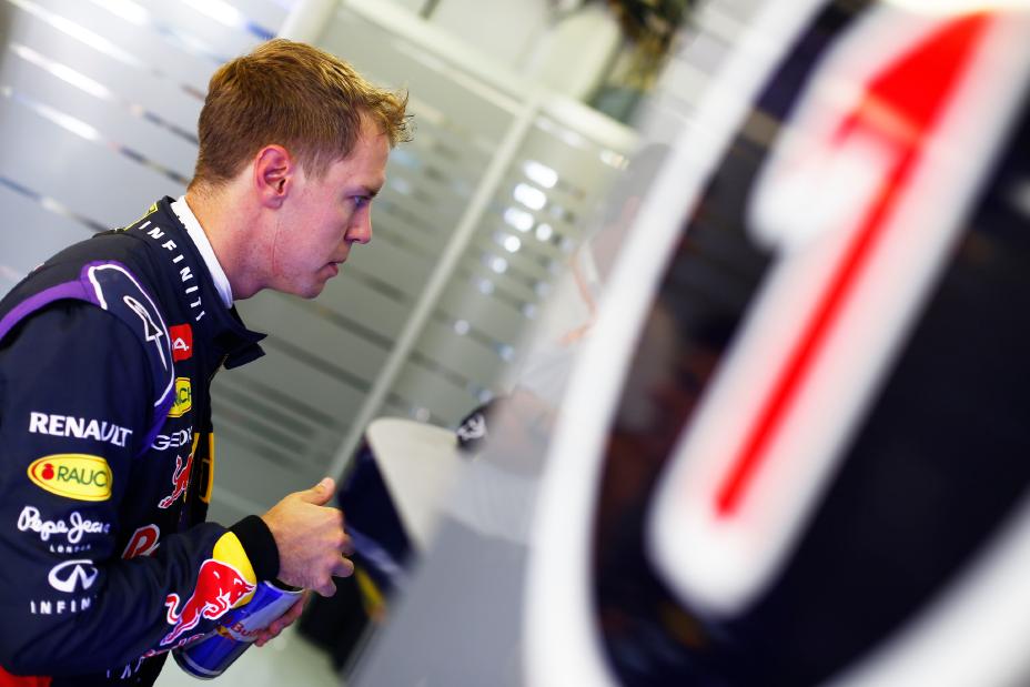 F1 driver looking at a monitor.